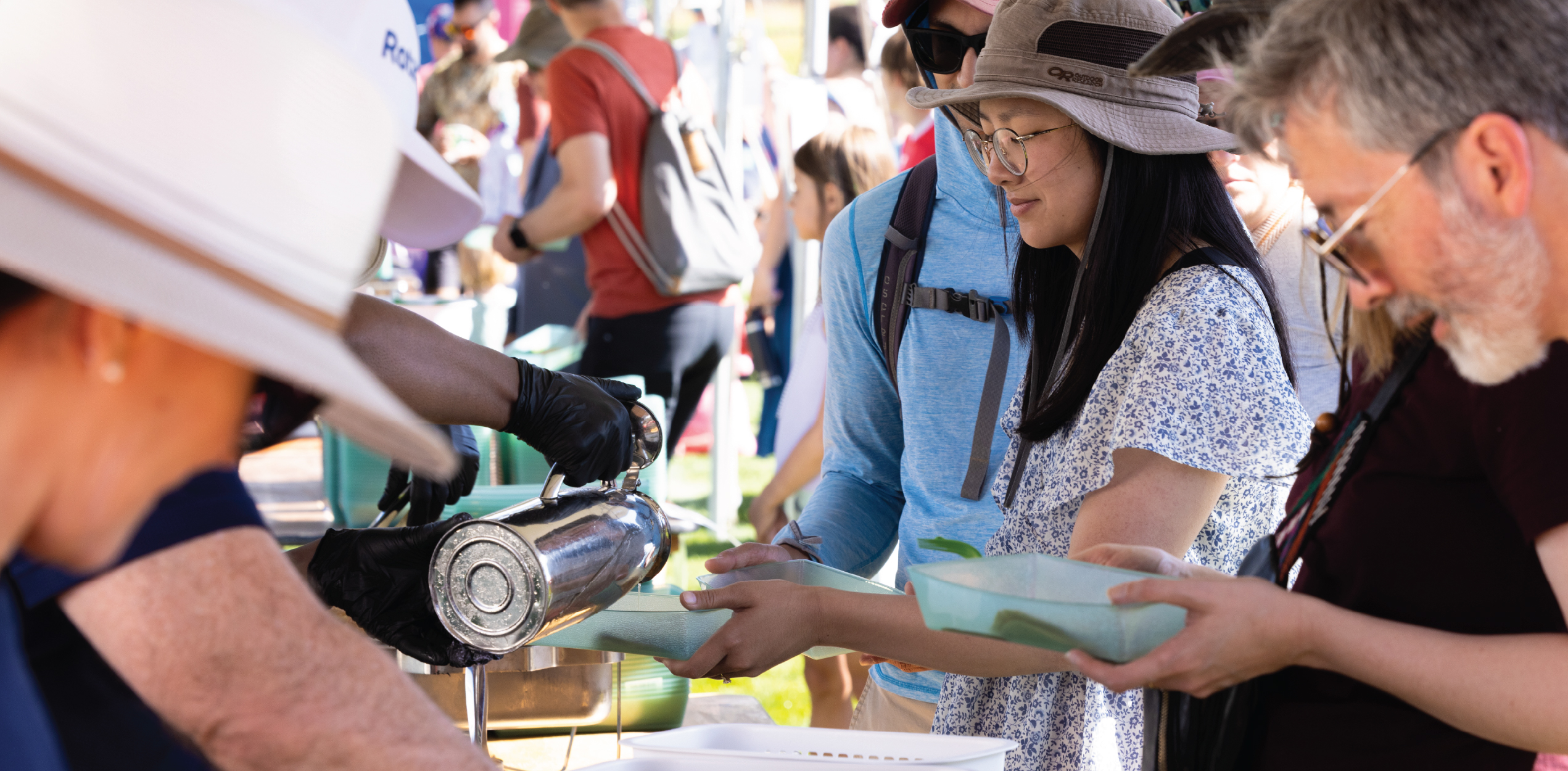 People grabbing pancakes during the pancake festival.