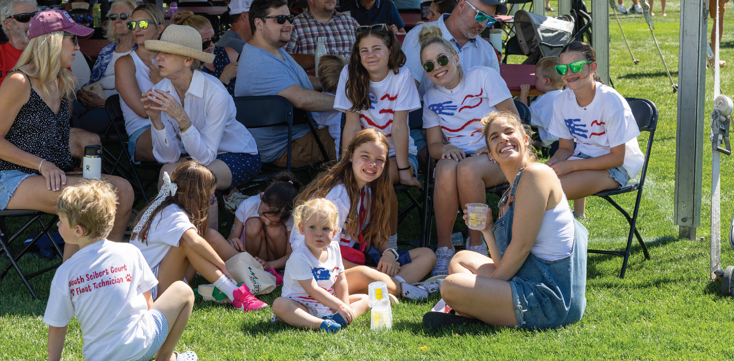 Group enjoying the festival under the shade.