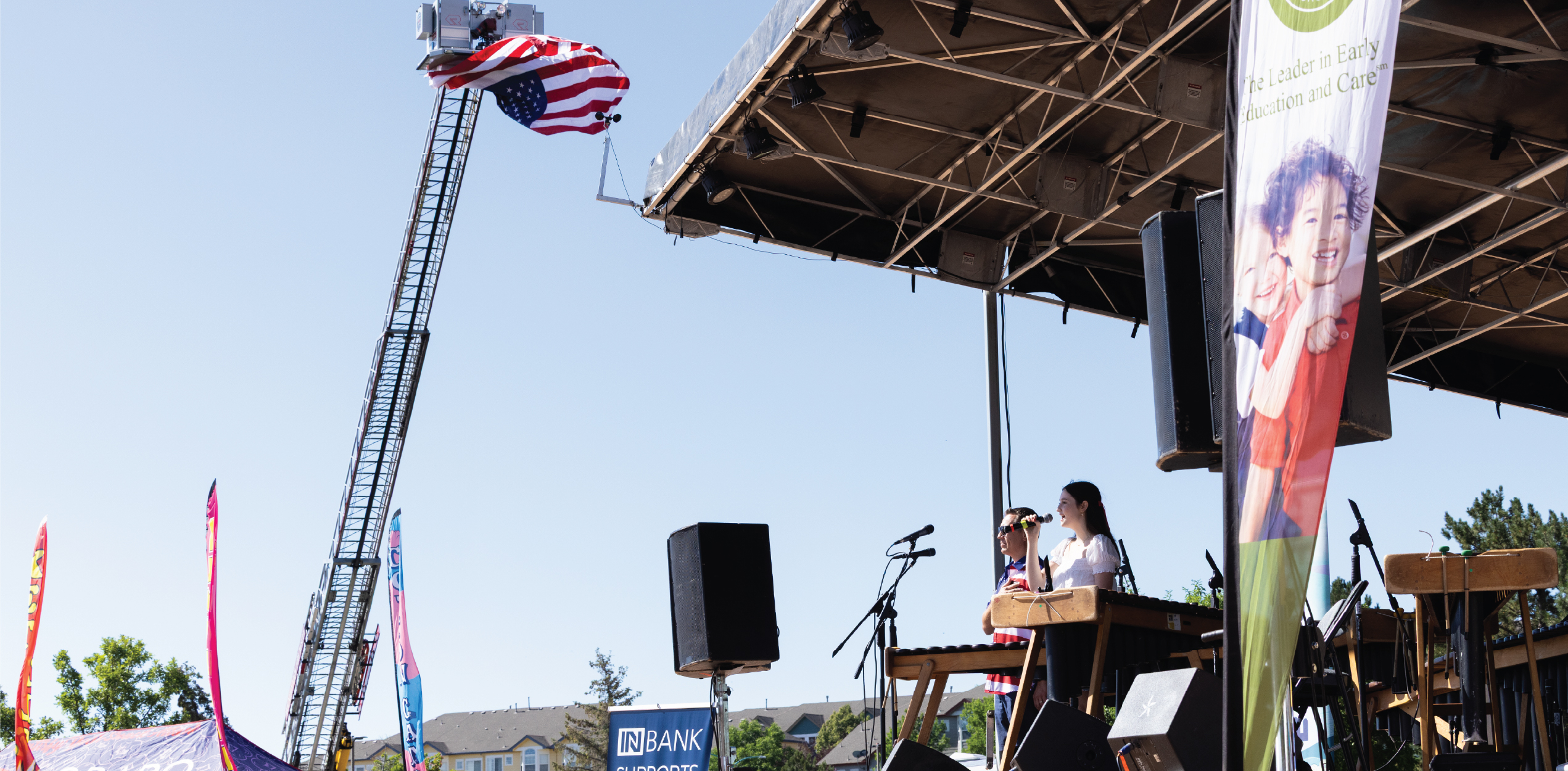 Person singing the national anthem while mountain view fire raises the flag.