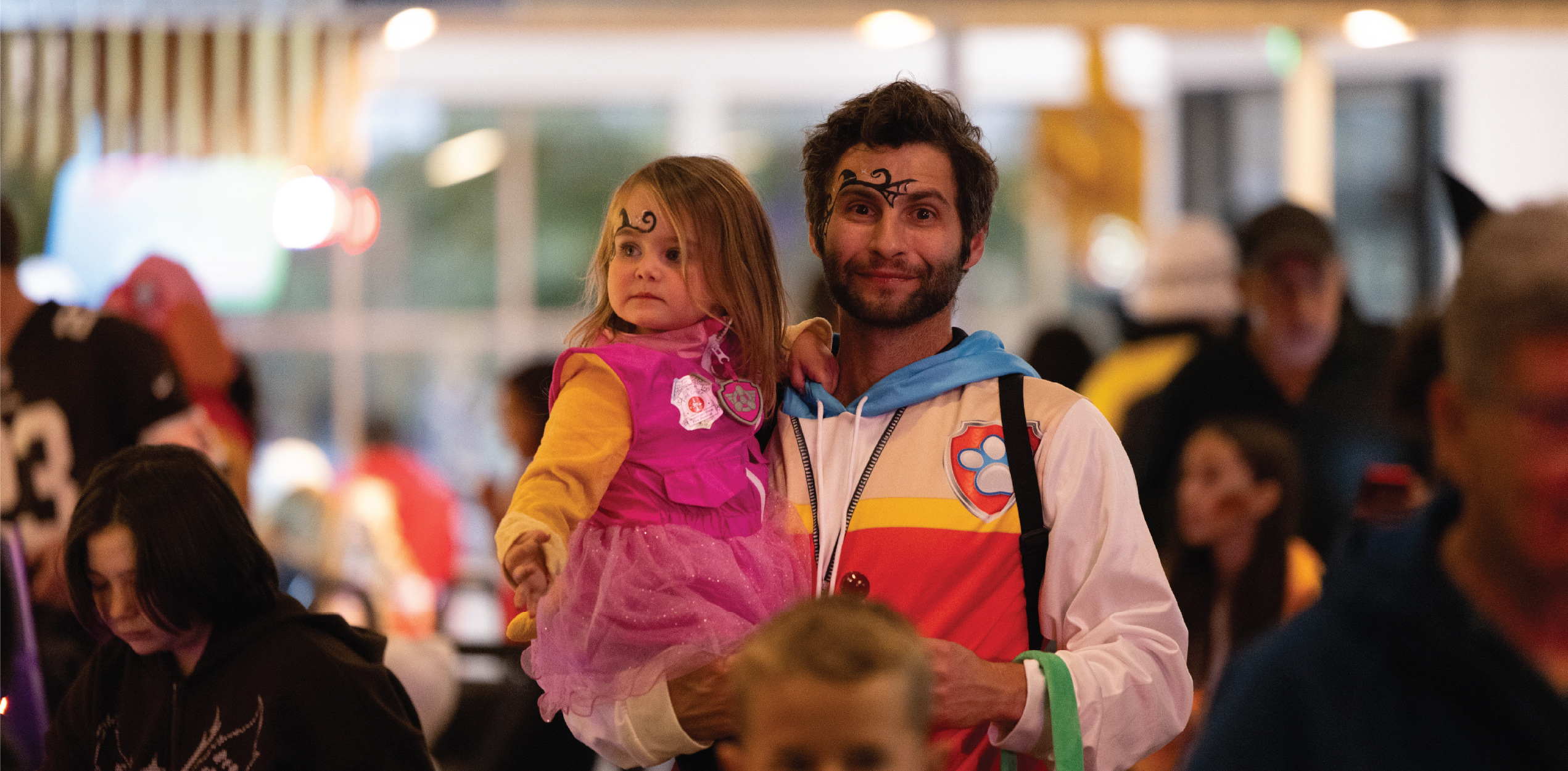 Parent holding their child, both dressed up!