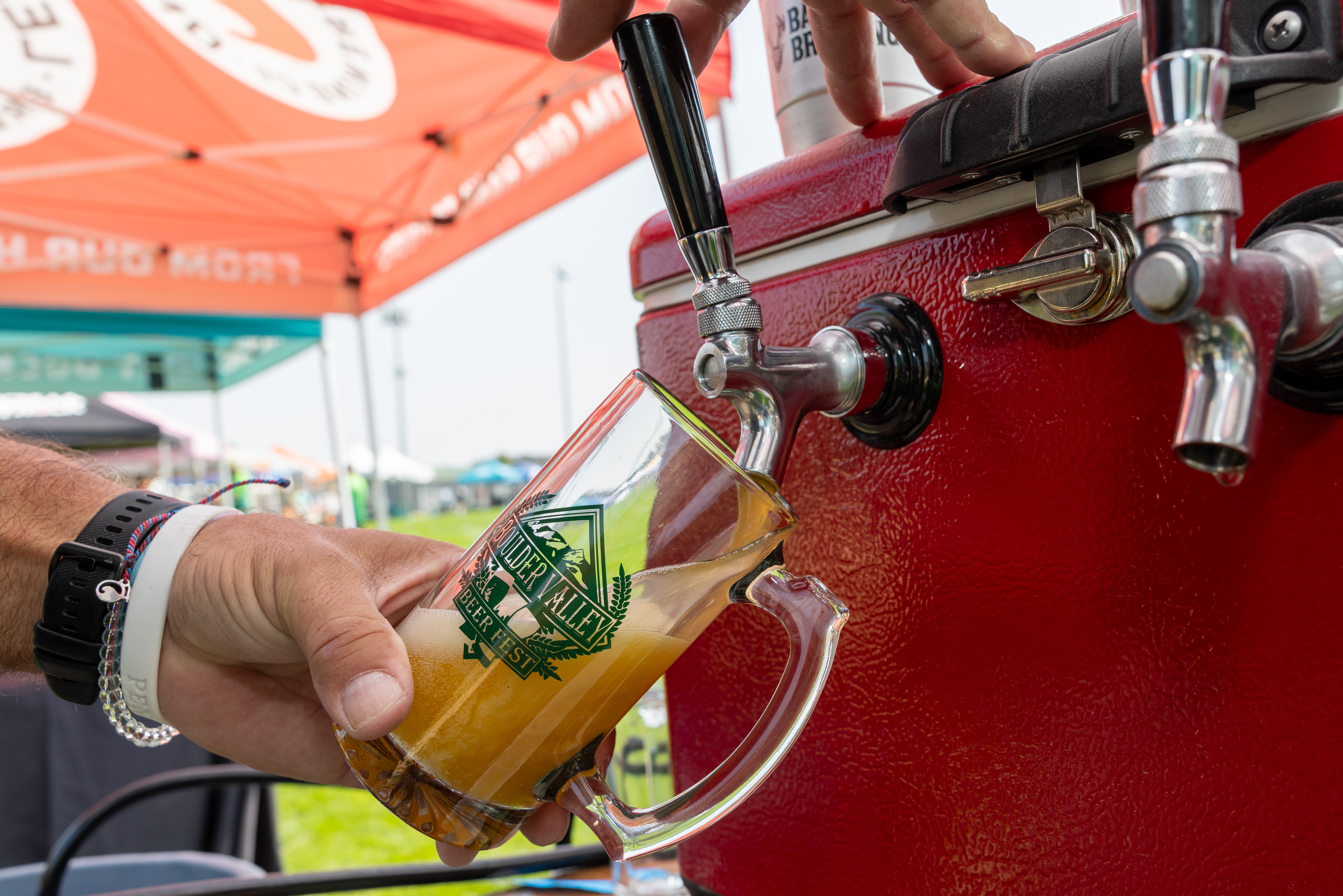 Person pouring a beer.