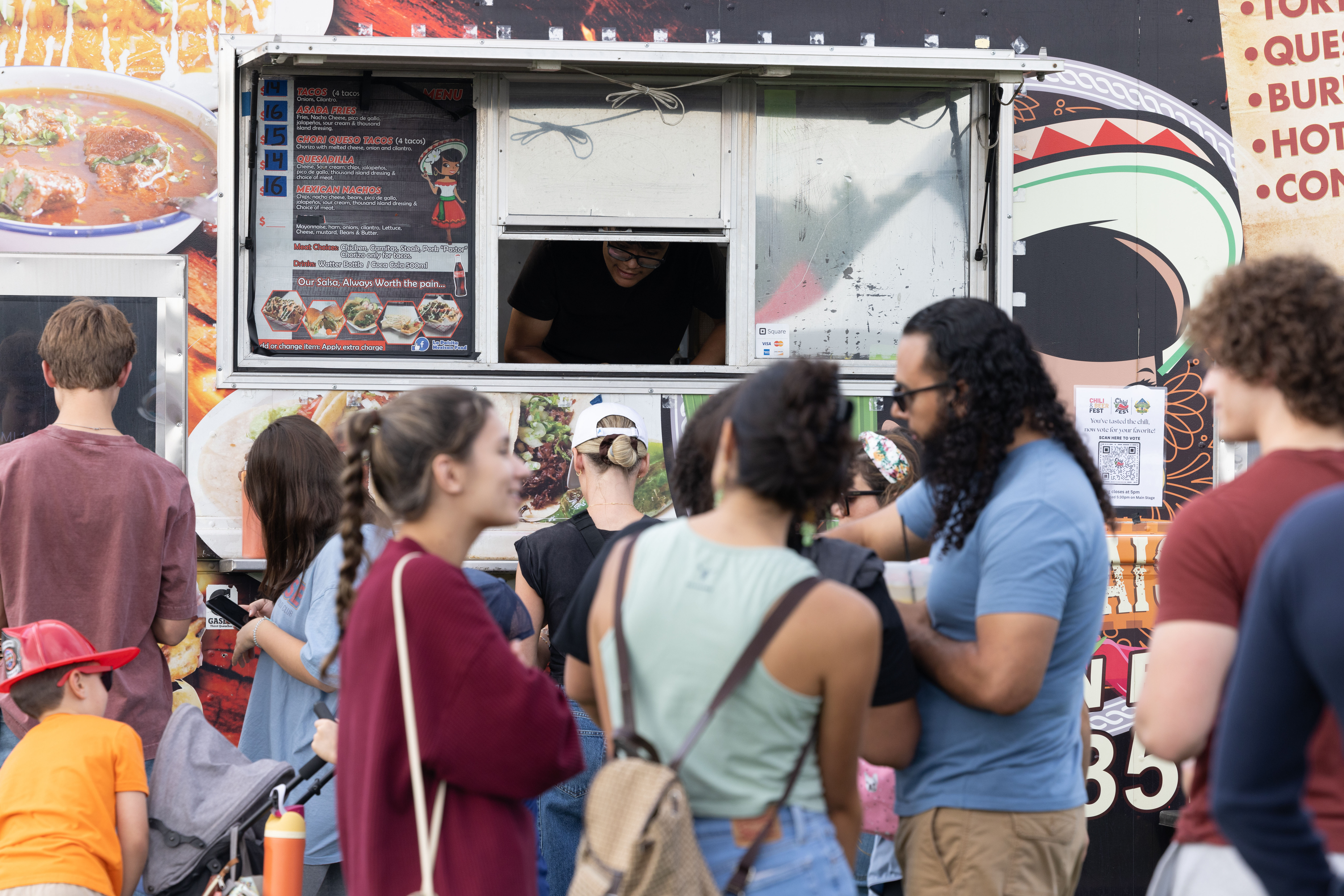 Person handing out food from a food truck.