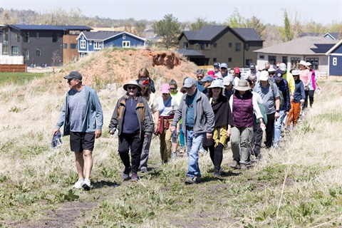 People walking through the open space to the historic minning site during the historic walk.