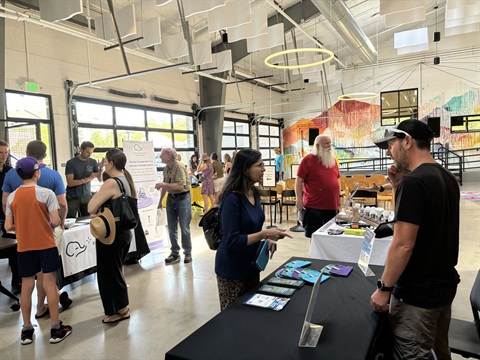 Attendees at the electrification expo talking to people at booths