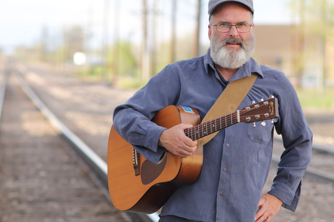 John McKay with a guitar.