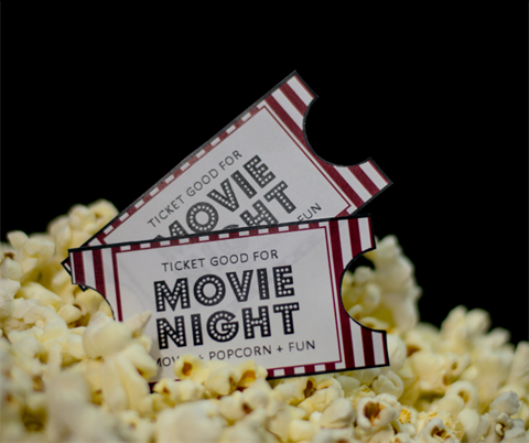 Ticket stubs and popcorn on a black background