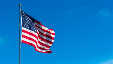American flag waving in the wind against the sky