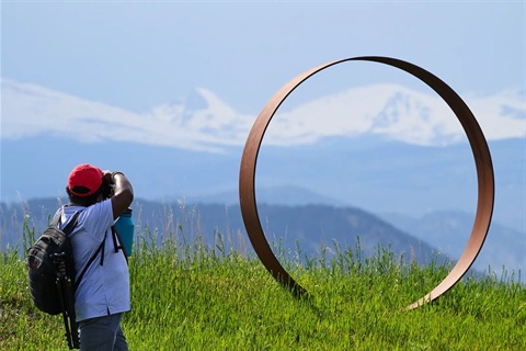 A person photographs public art in Superior
