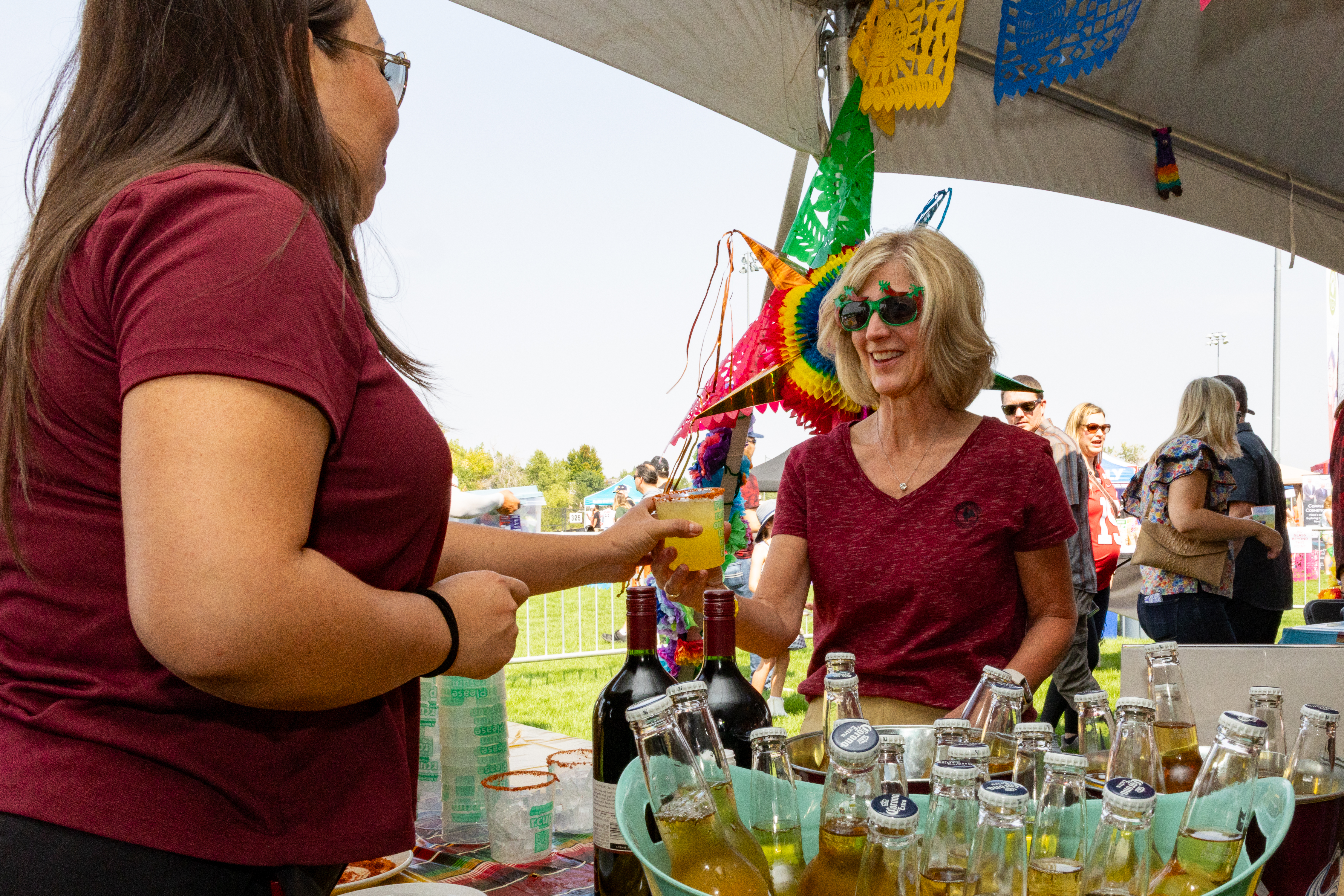Person being handed a beverage.