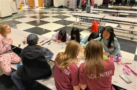Children and volunteers creating crafts at Parent's Night Out