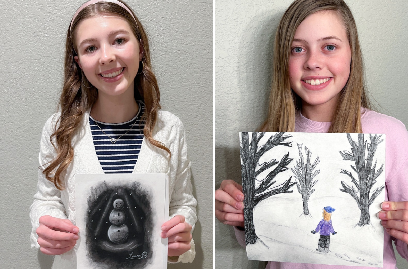 Jane and Livia holding their contents artwork.