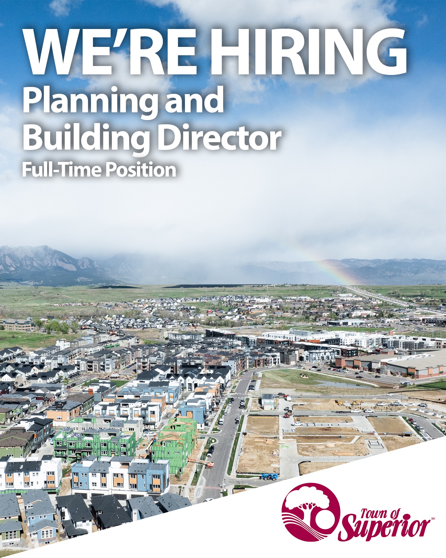 We're hiring text overlaying a drone photo of Superior with a rainbow being formed from a sun shower in the background.