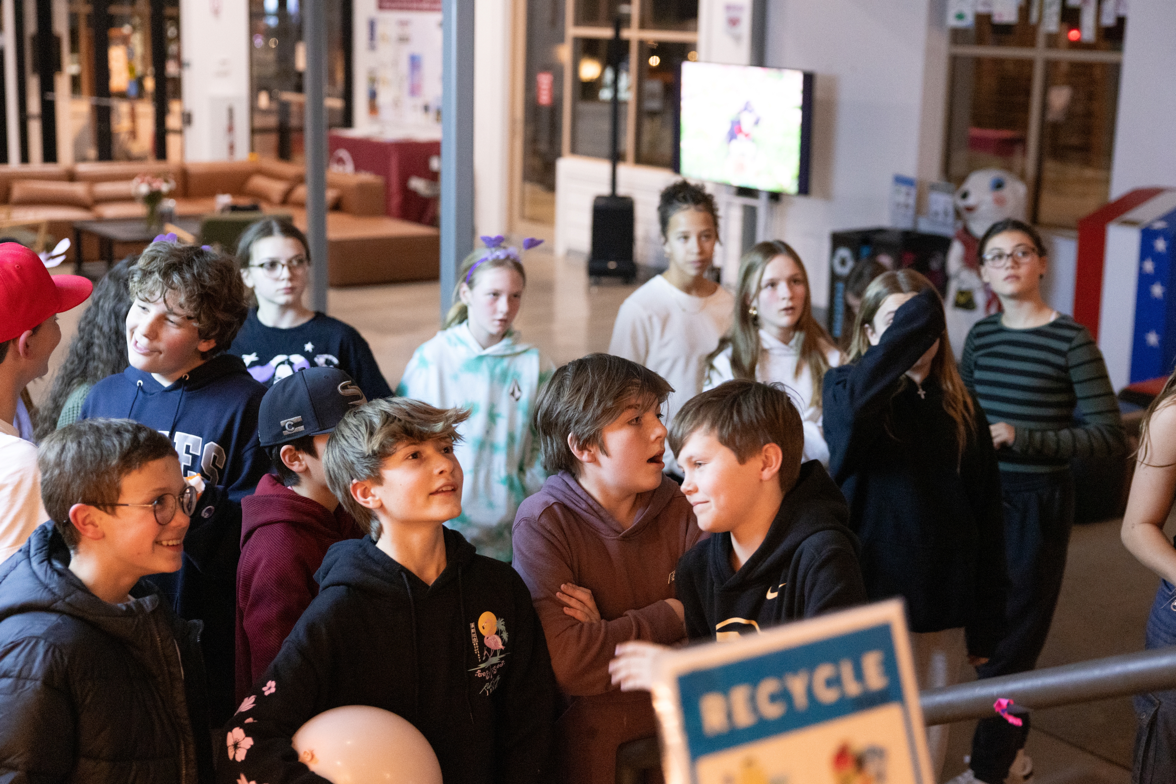 Youths standing around with looks of anticipation.