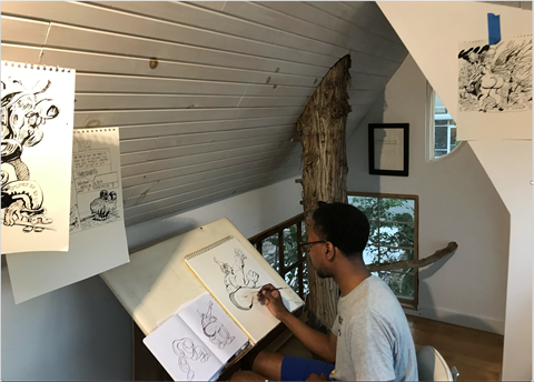 Black male artist sketching artwork from inside attic studio, a tree cuts through the floor and exits through the ceiling