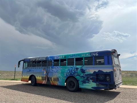 photo of the healing bus against a bright cloudy day